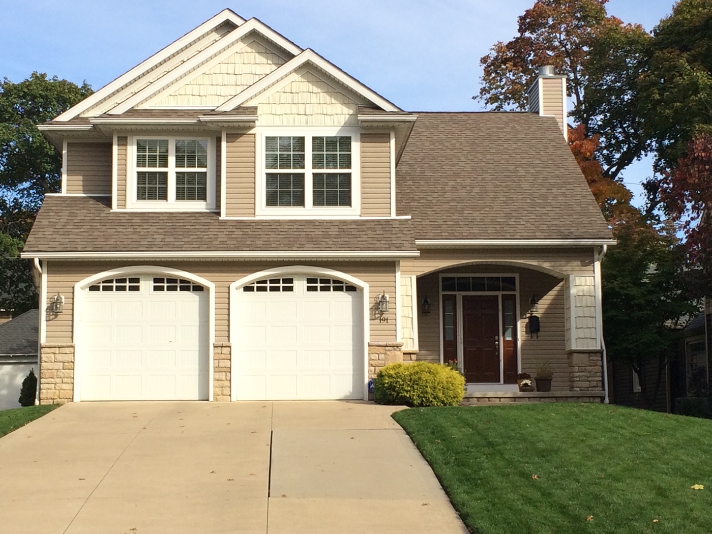 A finished new-construction home with a two-car garage and covered porch